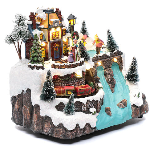 Musical christmas village with moving train and ice skating 25x25x15 cm 4