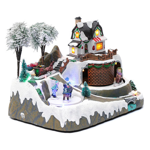 Bożonarodzeniowe miasteczko z melodią 20x25x20 cm dzieci na łyżwach poruszające się 3