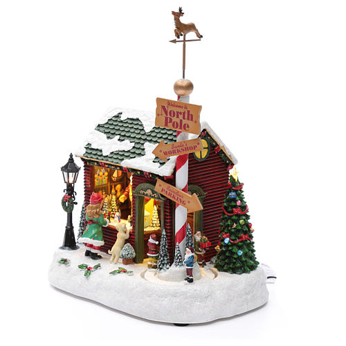 Scenka świąteczna podświetlana grająca Dom Świętego Mikołaja ruchome krasnoludki 30x25x17 cm 2