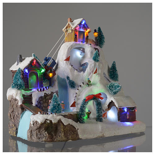 Christmas village illuminated with music, movement, ice rink and small lake 29X31X22 cm 3