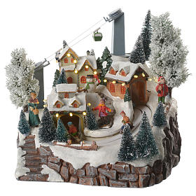 Illuminated christmas village with skiers, cableway and music 30x25x25 cm
