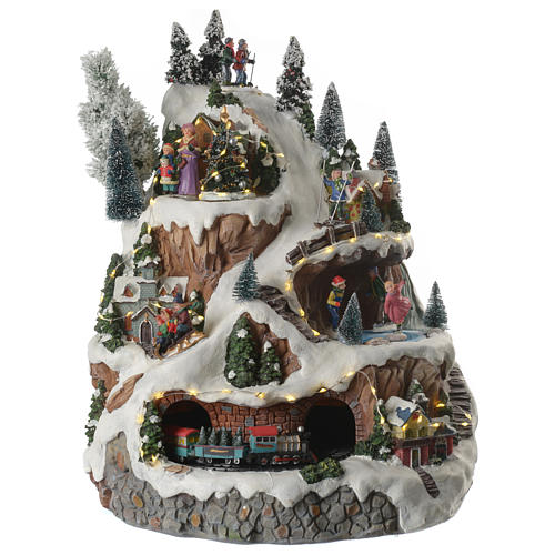 Christmas village with mountains equipped with illumination and movement 30x30x40 cm 1