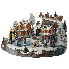 Christmas village with animated Santa Claus, skaters and lake sounds and lights 55x40x30 cm