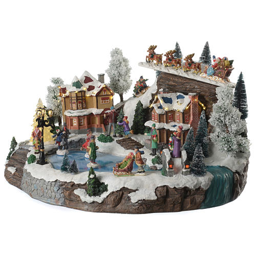 Christmas village with animated Santa Claus, skaters and lake sounds and lights 55x40x30 cm 2