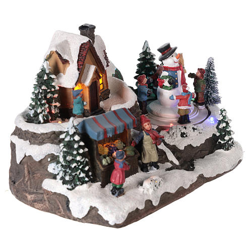 Christmas village with children and snow man equipped with lights and movement 25x15x15 cm 4