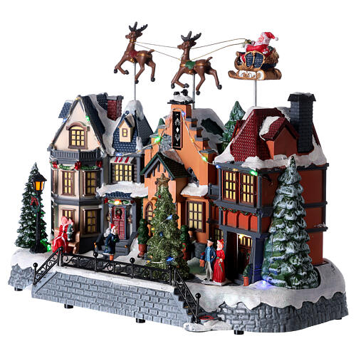 Cenário natalino aldeia com Pai Natal e renas movimento, luzes e música, corrente 220 V, 32x37x20 cm 3