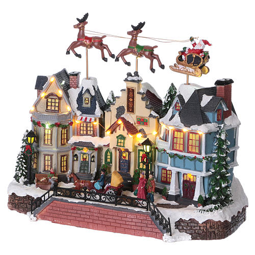 Christmas village with lights and moving Santa Claus with reindeers 30x35x20 cm 3