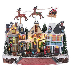 Village de Noël Père Noël rennes mouvement 30x35x20 cm lumières musique courant
