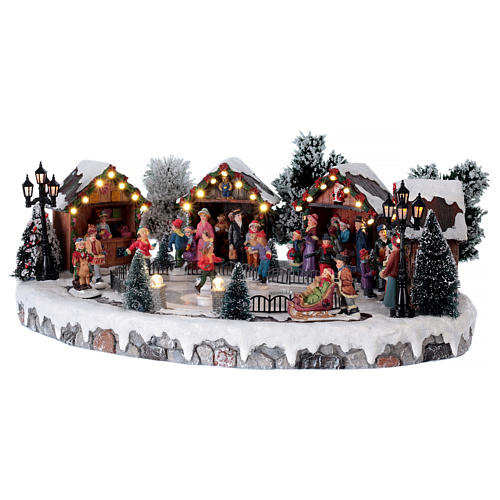 Christmas village with lights and six moving ice skaters 20x45x35 cm 3