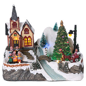 Illuminated Christmas village with rotating tree, singing children 20x25x16 cm