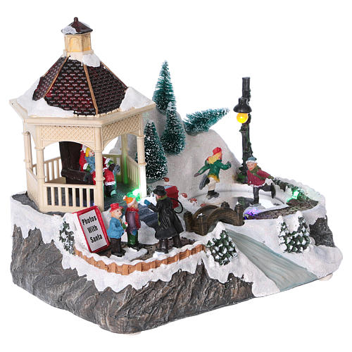 Christmas village with lights, moving ice skaters and Santa Claus 20x25x16 cm 4