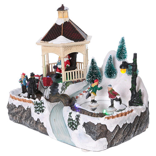 Illuminated Christmas village with animated ice skaters and Santa Claus 20x25x16 cm 3
