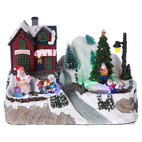 Christmas village with lights, moving tree, Santa Claus and elves 20x25x16 cm