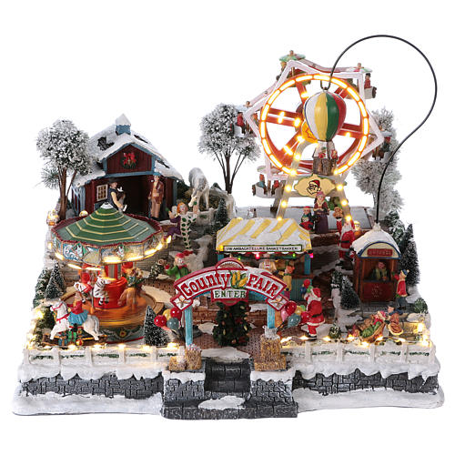 Weihnachtsdorf, mit Beleuchtung, Musik und beweglichen Jahrmarktsattraktionen, 30x45x35 cm, Netzanschluss 1