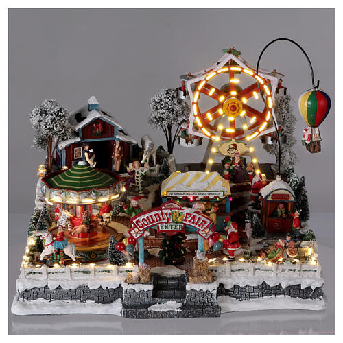 Weihnachtsdorf, mit Beleuchtung, Musik und beweglichen Jahrmarktsattraktionen, 30x45x35 cm, Netzanschluss 2
