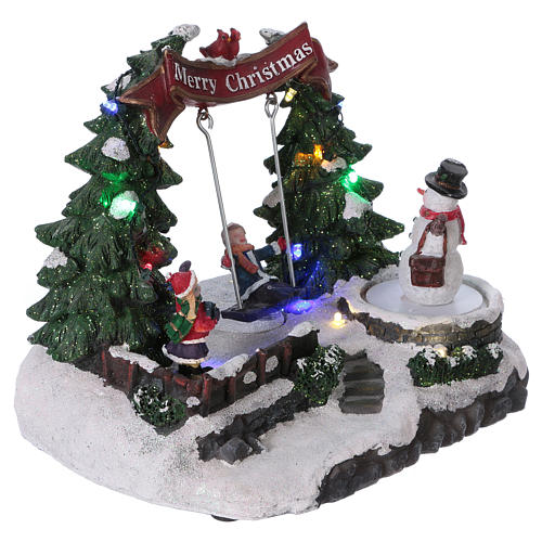 Christmas village with moving snowman and swing 20x20x20 cm 4