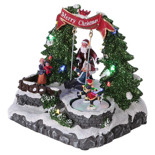 Christmas village with LED lights, moving ice-skaters and swing 20x25x20 cm 3