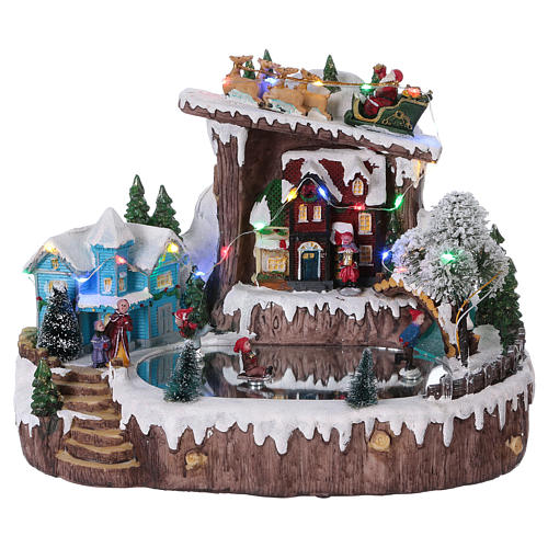 Christmas village with moving ice-skaters 25x30x20 cm 1
