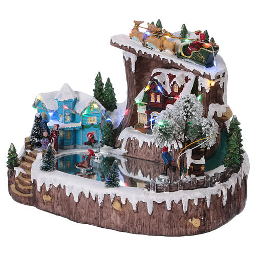 Christmas village with moving ice-skaters 25x30x20 cm 3