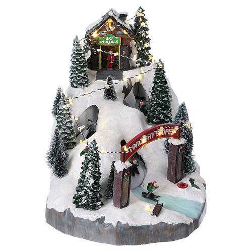 Christmas village 25x25x35 cm with moving skiers requiring batteries or electricity 1