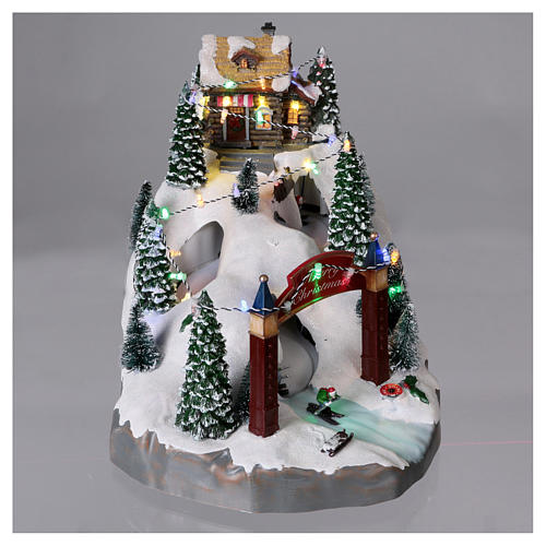 Christmas village 25x25x35 cm with moving skiers requiring batteries or electricity 2