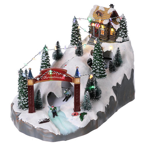Christmas village 25x25x35 cm with moving skiers requiring batteries or electricity 3