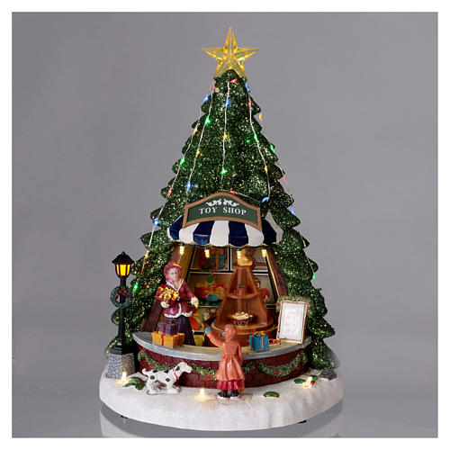 Christmas village with moving toy-shop scene and tree 30x25x25 cm 2