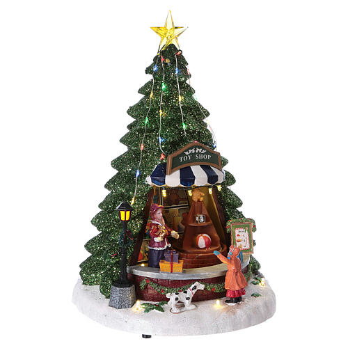 Christmas village with moving toy-shop scene and tree 30x25x25 cm 4