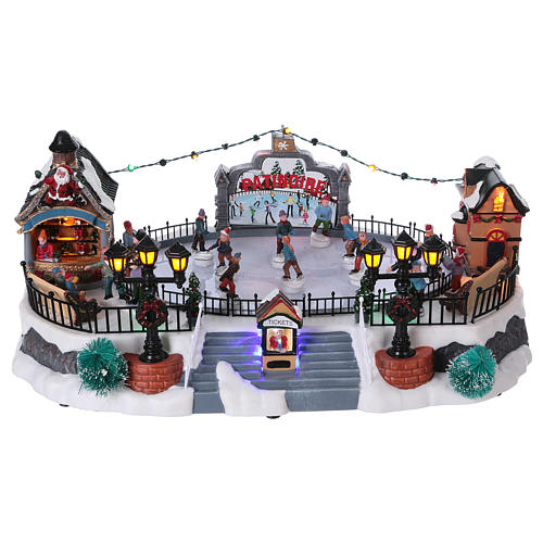 Christmas village with moving ice-skaters and Santa Claus 20x40x25 cm 1