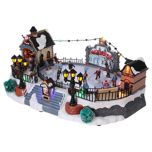 Christmas village with moving ice-skaters and Santa Claus 20x40x25 cm 3