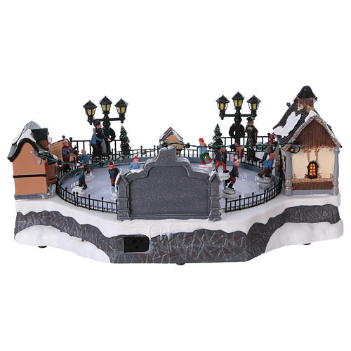 Christmas village with moving ice-skaters and Santa Claus 20x40x25 cm 5