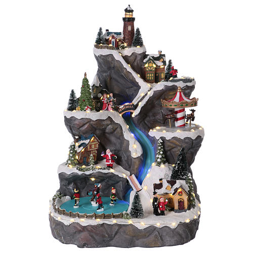 Christmas village with LED lights, moving ice-skaters, carousel and trees 50x30x30 cm 1