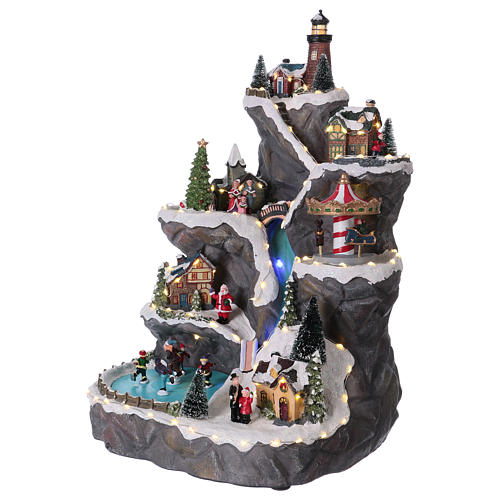 Christmas village with LED lights, moving ice-skaters, carousel and trees 50x30x30 cm 3