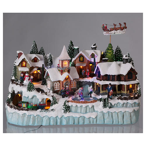 Christmas village with LED lights, ice-skaters and moving train 40x55x30 cm 2