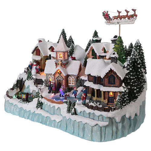 Christmas village with LED lights, ice-skaters and moving train 40x55x30 cm 3