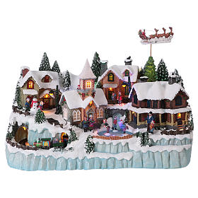 Christmas Village Scene with In-Motion Skaters and Train 40x55x30 cm electric powered