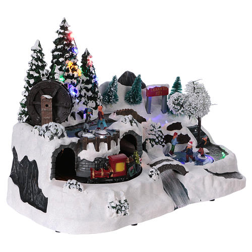 Christmas village with LED lights, moving ice-skaters and train 25x35x20 cm 4