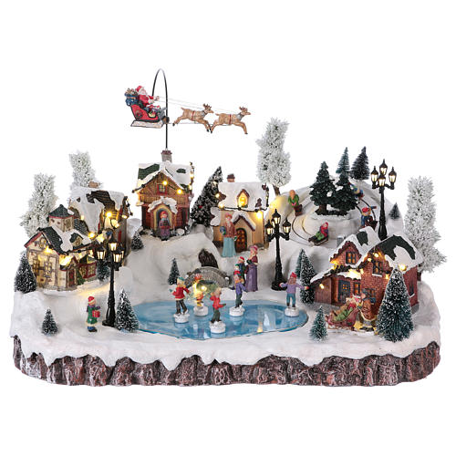 Weihnachtsdorf, mit Beleuchtung, Musik und beweglichem Weihnachtsmann und Eisläufern, 30x50x35 cm, Netzanschluss 1