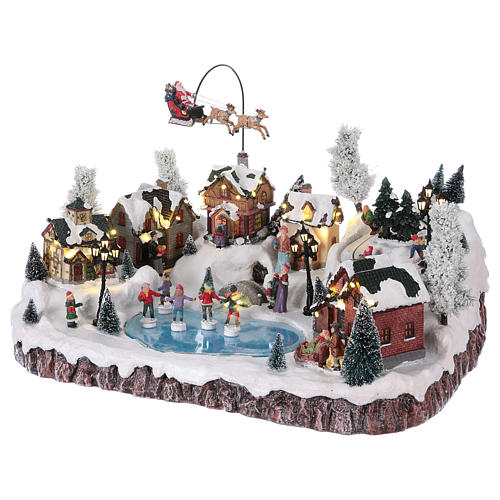 Weihnachtsdorf, mit Beleuchtung, Musik und beweglichem Weihnachtsmann und Eisläufern, 30x50x35 cm, Netzanschluss 3