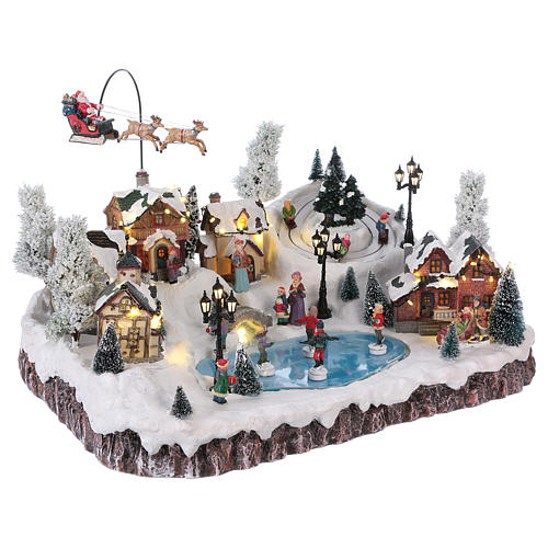 Weihnachtsdorf, mit Beleuchtung, Musik und beweglichem Weihnachtsmann und Eisläufern, 30x50x35 cm, Netzanschluss 4