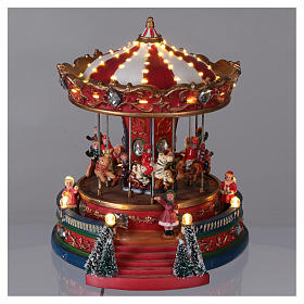Village de Noël avec carrousel mouvement lumières musique 25x20x25 cm courant