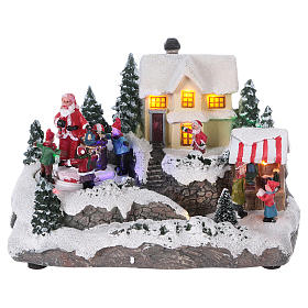 Christmas Village with Santa children and gifts 15x20x15 cm lights and motion battery powered