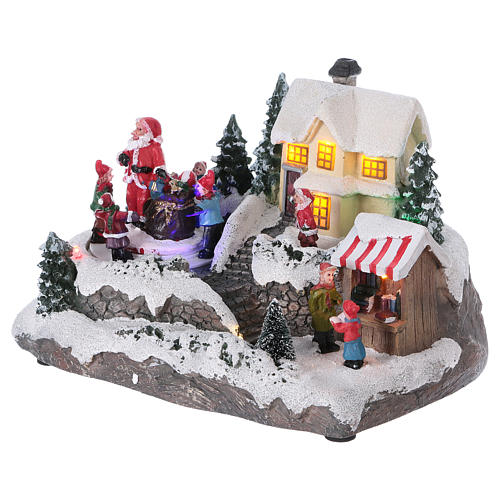 Christmas Village with Santa children and gifts 15x20x15 cm lights and motion battery powered 3