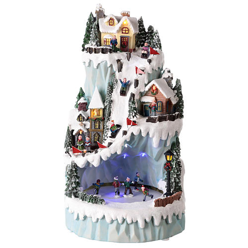 Weihnachtsdorf mit beweglichen Eisläufern, aus Kunstharz, 20x35x20 cm 1