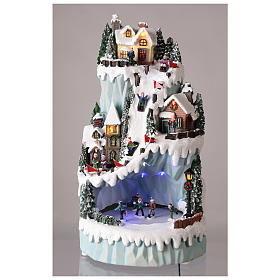 Christmas village in resin 43x24 cm with moving ice skating rink s2