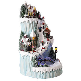 Christmas village in resin 43x24 cm with moving ice skating rink s4