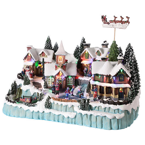 Christmas village with moving Santa sleigh 40x55x30 cm 3