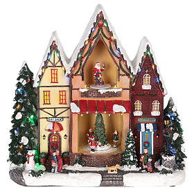 Casa di Natale con movimenti luci e musica 35x35x15 cm