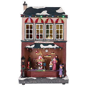 Casa de Navidad con tiovivo y Papá Noel 45x25x20 cm