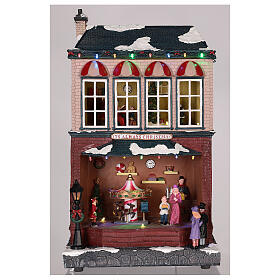 Casa de Navidad con tiovivo y Papá Noel 45x25x20 cm